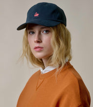 Load image into Gallery viewer, Model wearing Merz B. Schwanen - Good Basics Swan Logo Cap in Charcoal