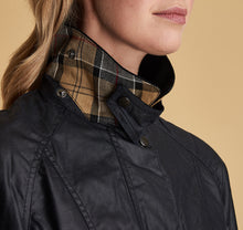 Load image into Gallery viewer, Model wearing Barbour Beadnell wax jacket in navy.
