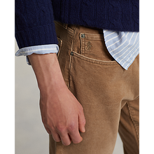 Load image into Gallery viewer, Model wearing Polo Ralph Lauren - Varick Slim Straight Stretch Corduroy 5-Pocket Pant in Vintage Tan.