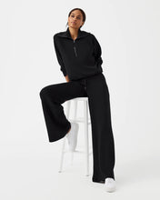 Load image into Gallery viewer, Model wearing Spanx - Air Essentials Wide Leg Pant in Very Black.
