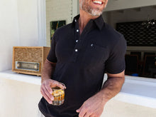 Load image into Gallery viewer, Model wearing  Criquet - Top-Shelf Players Polo in Black Top.
