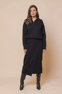 Model wearing Rino & Pelle - Janou Midi Skirt in Black.