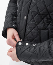 Load image into Gallery viewer, Model wearing Barbour Yarrow Quilt in Black/Rose Garden Floral.

