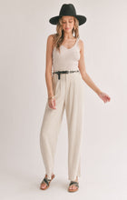 Load image into Gallery viewer, Model wearing Sadie &amp; Sage - La Luna Pleated Trousers in Oatmeal.
