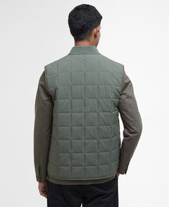 Model wearing Barbour Elmstone Quilted Gilet in Uniform Green - back.