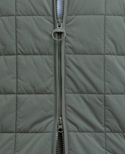 Model wearing Barbour Elmstone Quilted Gilet in Uniform Green.
