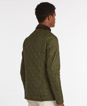 Load image into Gallery viewer, Model wearing Barbour Heritage Liddesdale Quilt in Olive.
