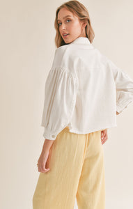Model wearing Sadie & Sage - No Stress Puff Sleeve Denim Jacket in White - back.