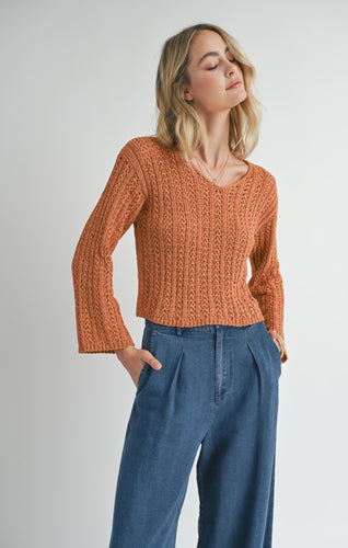 Model wearing Sadie & Sage Perfect Flow Pointelle Knit Sweater in Pumpkin.