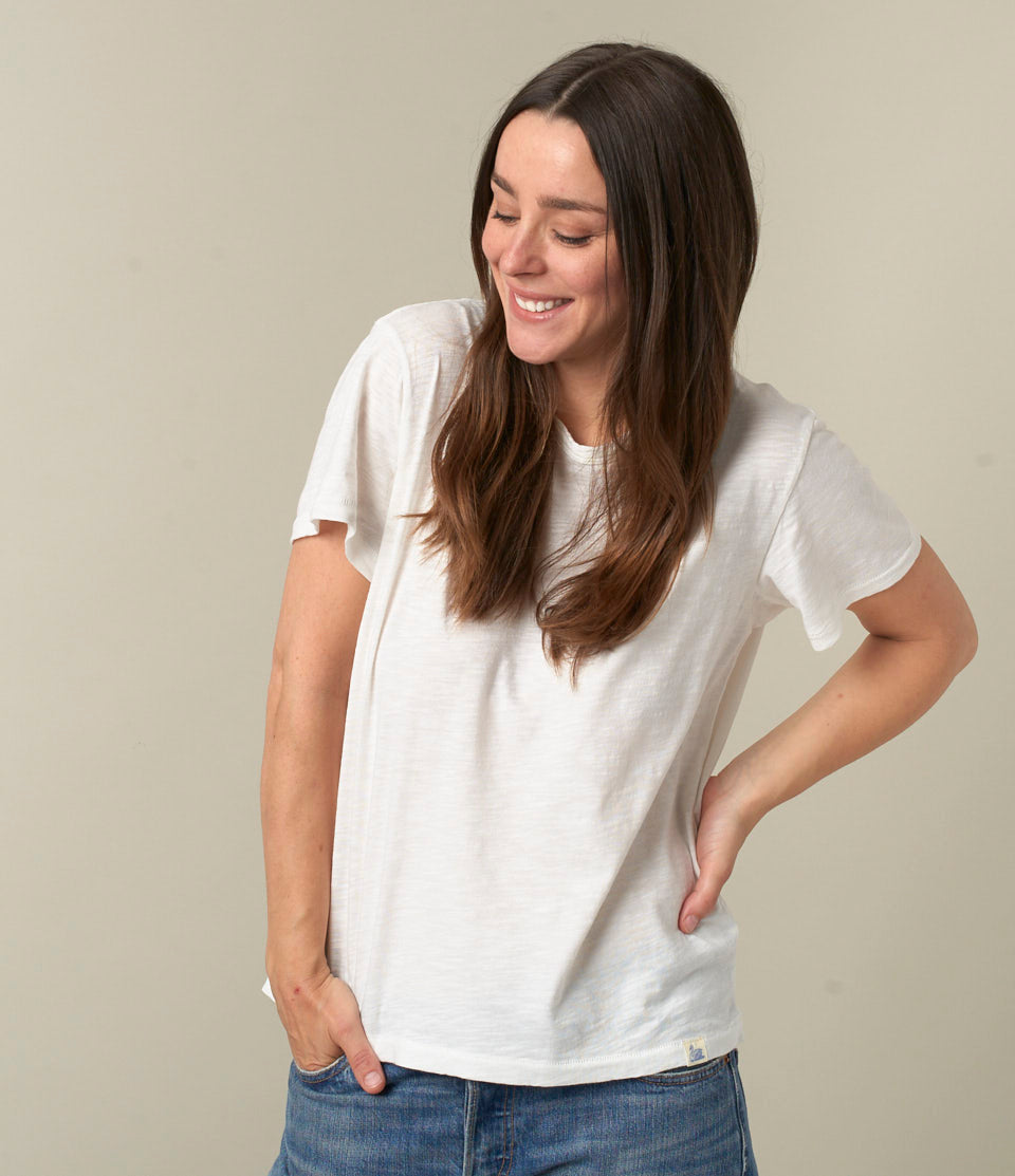 Model wearing Merz B. Schwanen - Good Basics Unisex T-shirt in White.