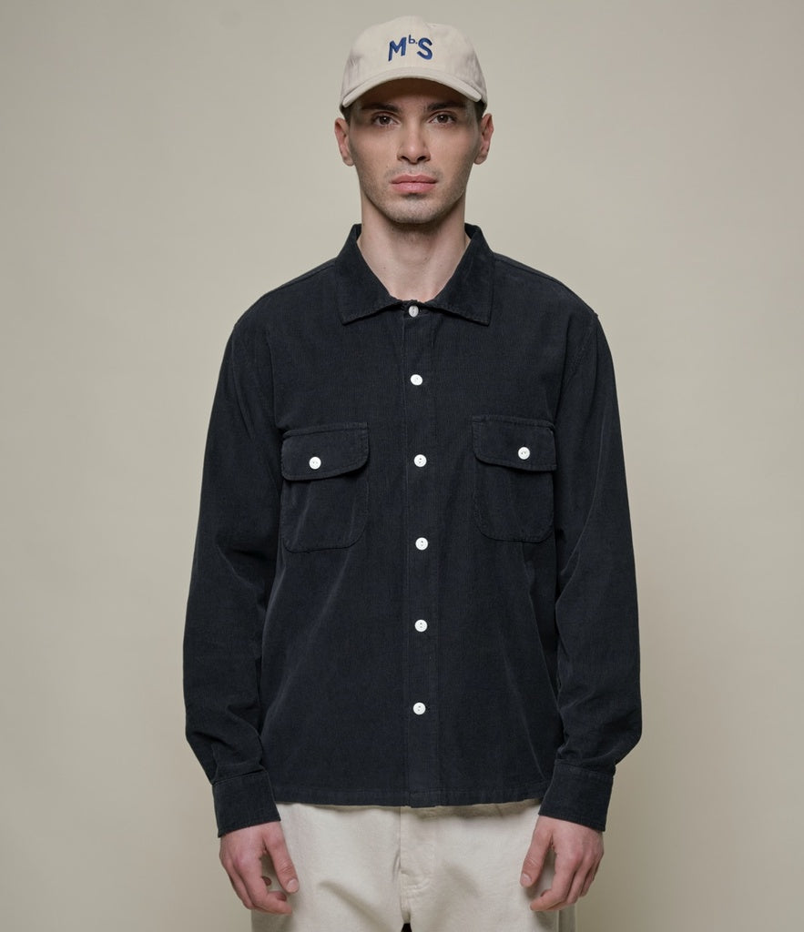 Model wearing Merz B. Schwanen - Good Basics Corduroy Overshirt in Deep Black.