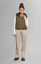 Load image into Gallery viewer, Model wearing Alp N Rock - Sonja Reversible Short Vest in Dark Moss.
