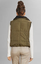 Load image into Gallery viewer, Model wearing Alp N Rock - Sonja Reversible Short Vest in Dark Moss.
