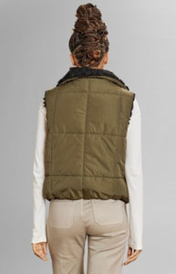 Model wearing Alp N Rock - Sonja Reversible Short Vest in Dark Moss.