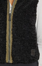 Load image into Gallery viewer, Model wearing Alp N Rock - Sonja Reversible Short Vest in Dark Moss.
