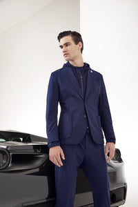 Model wearing TMB - Performance Travel Suit in Navy.