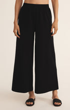 Load image into Gallery viewer, Model wearing ZSupply - Scout Jersey Pant in Black.

