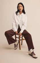 Load image into Gallery viewer, Model wearing ZSupply Saunder Track Pant in Sandalwood.
