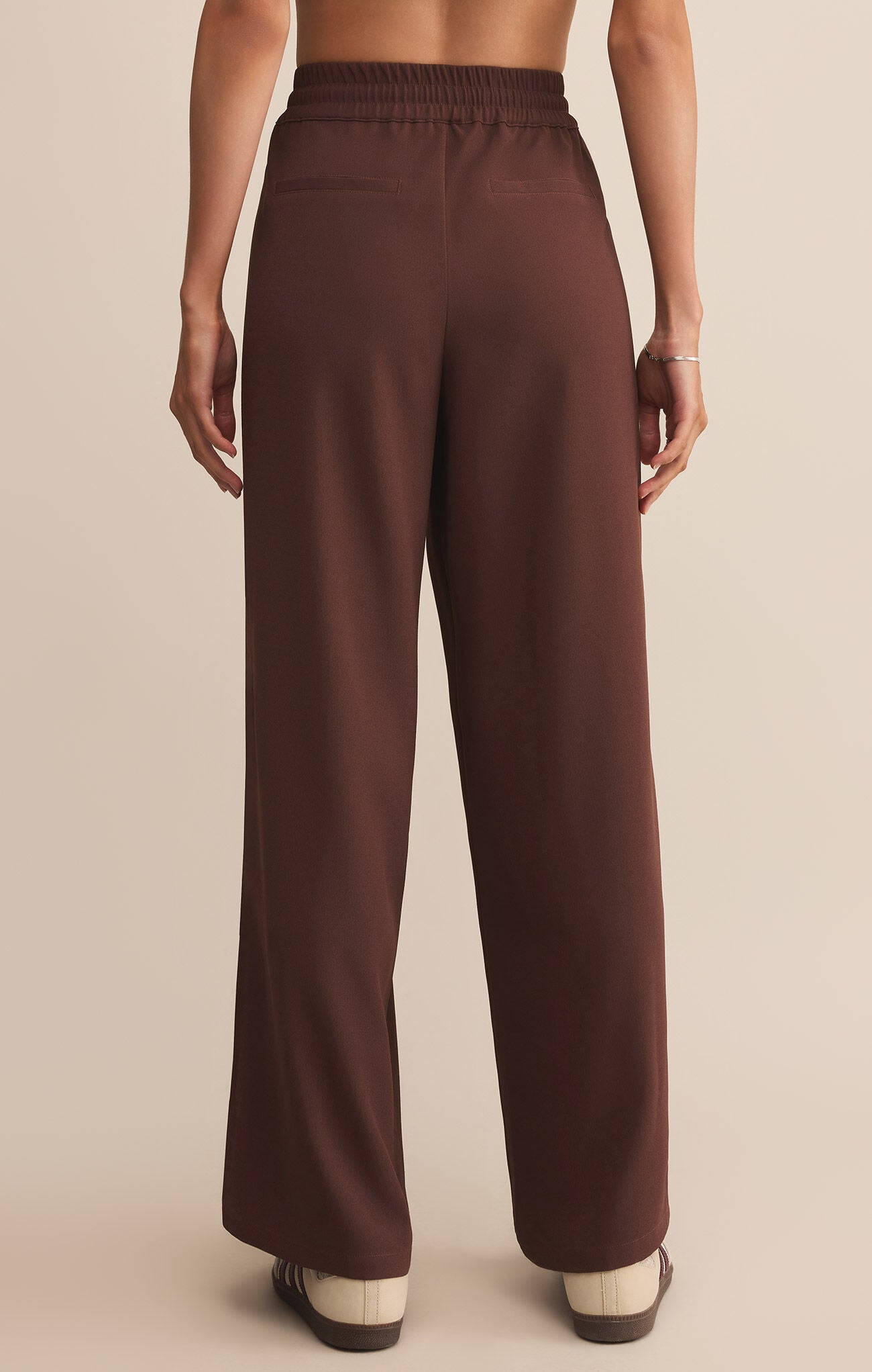 Model wearing ZSupply Saunder Track Pant in Sandalwood - back.
