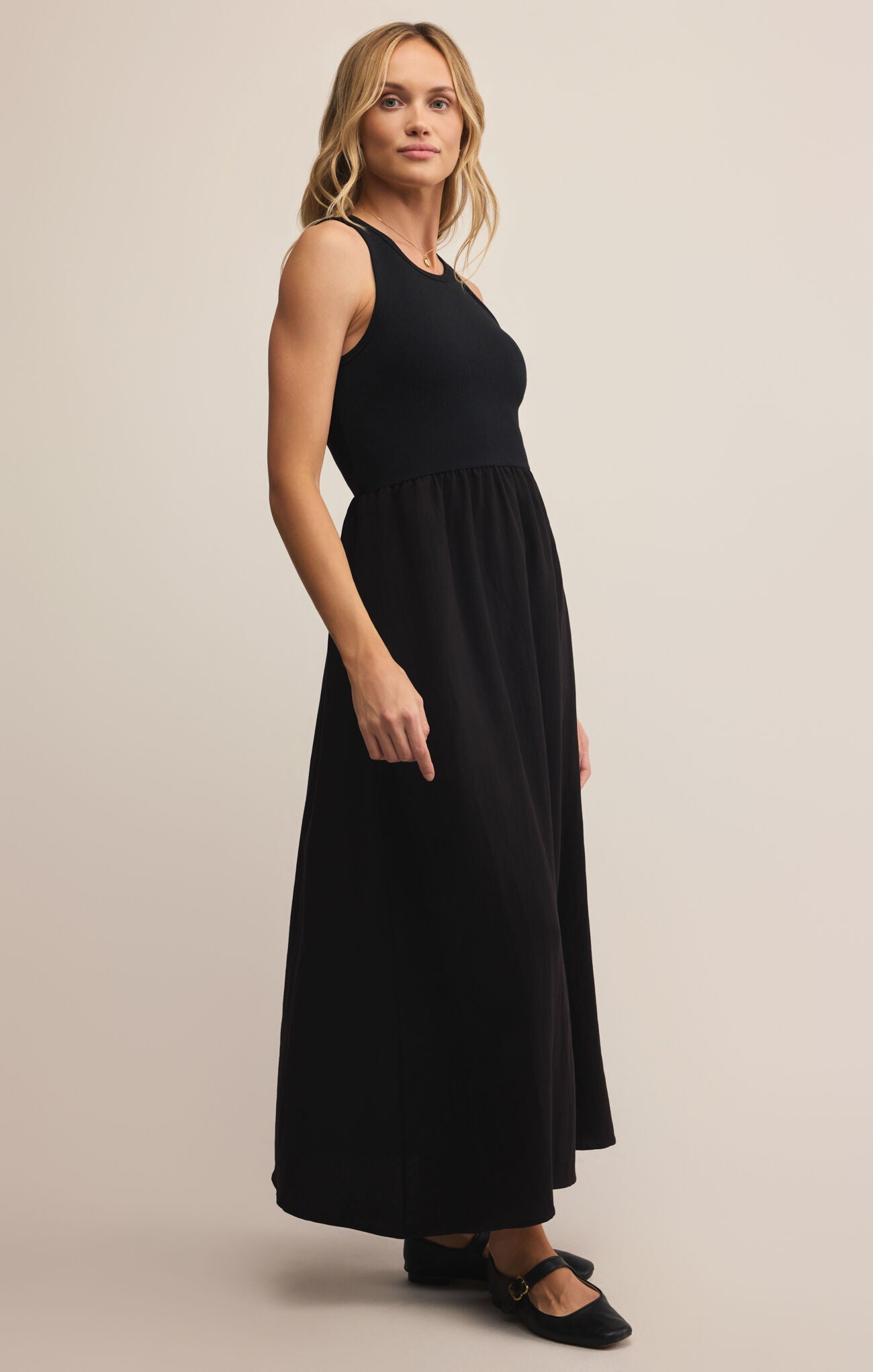 Model wearing ZSupply Charlotte Midi Dress in Black.