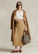 Load image into Gallery viewer, Model wearing Polo Ralph Lauren - Satin Pleated A-Line Midi Skirt in Camel.
