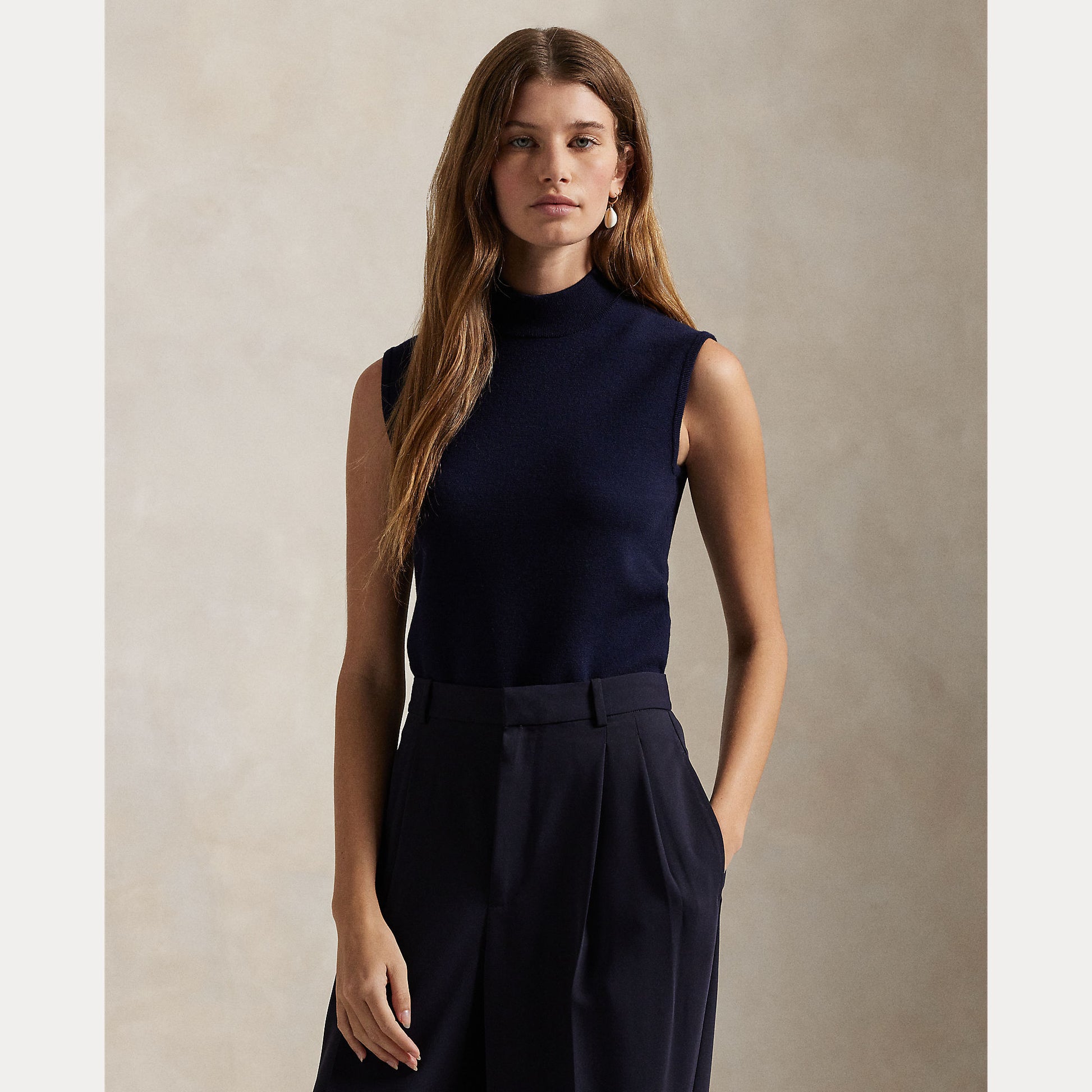 Model wearing Polo Ralph Lauren - Sleeveless Turtleneck Sweater in Hunter Navy.