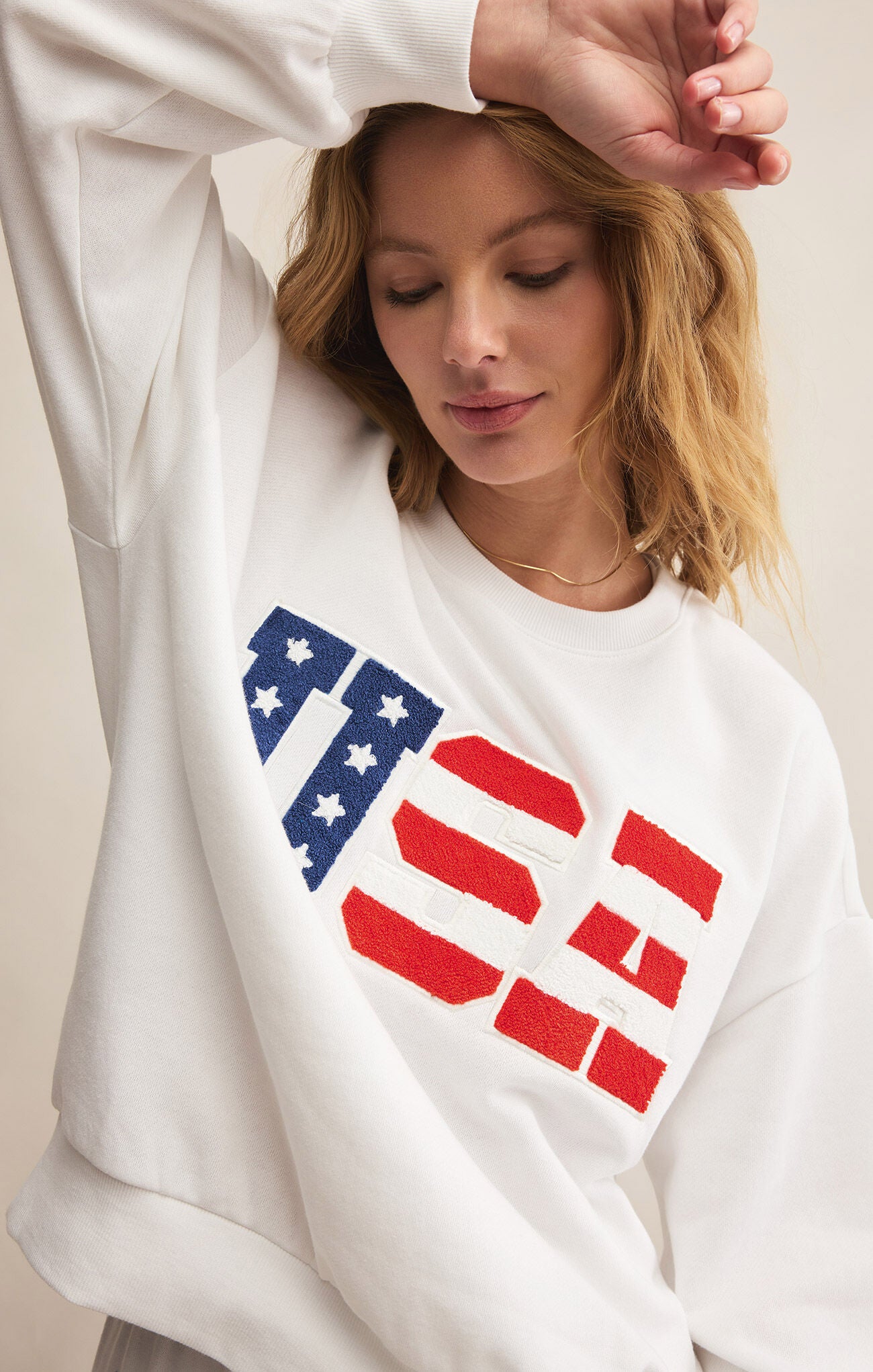 Model wearing ZSupply - Oversized USA Sweatshirt in White.