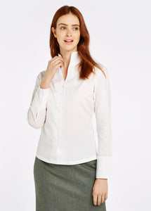 Model wearing Dubarry Snowdrop long sleeve button down shirt in white.