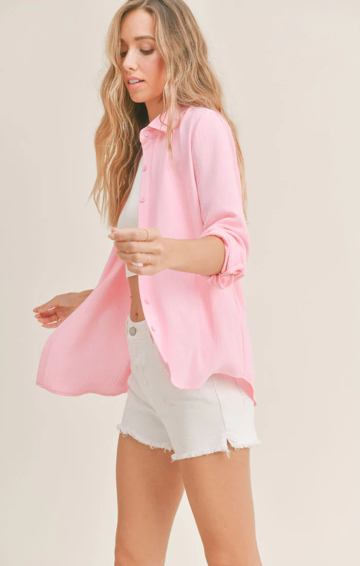 Model wearing Sadie & Sage - So Posh Button Down Shirt in Pink.