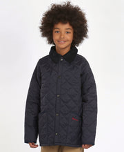 Load image into Gallery viewer, Model wearing Barbour Youth Liddesdale Quilt in Navy.
