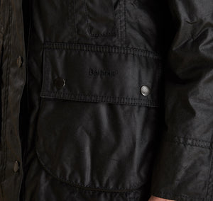 Model wearing Barbour Beadnell wax jacket in black.