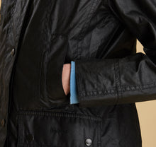 Load image into Gallery viewer, Model wearing Barbour Beadnell wax jacket in black.
