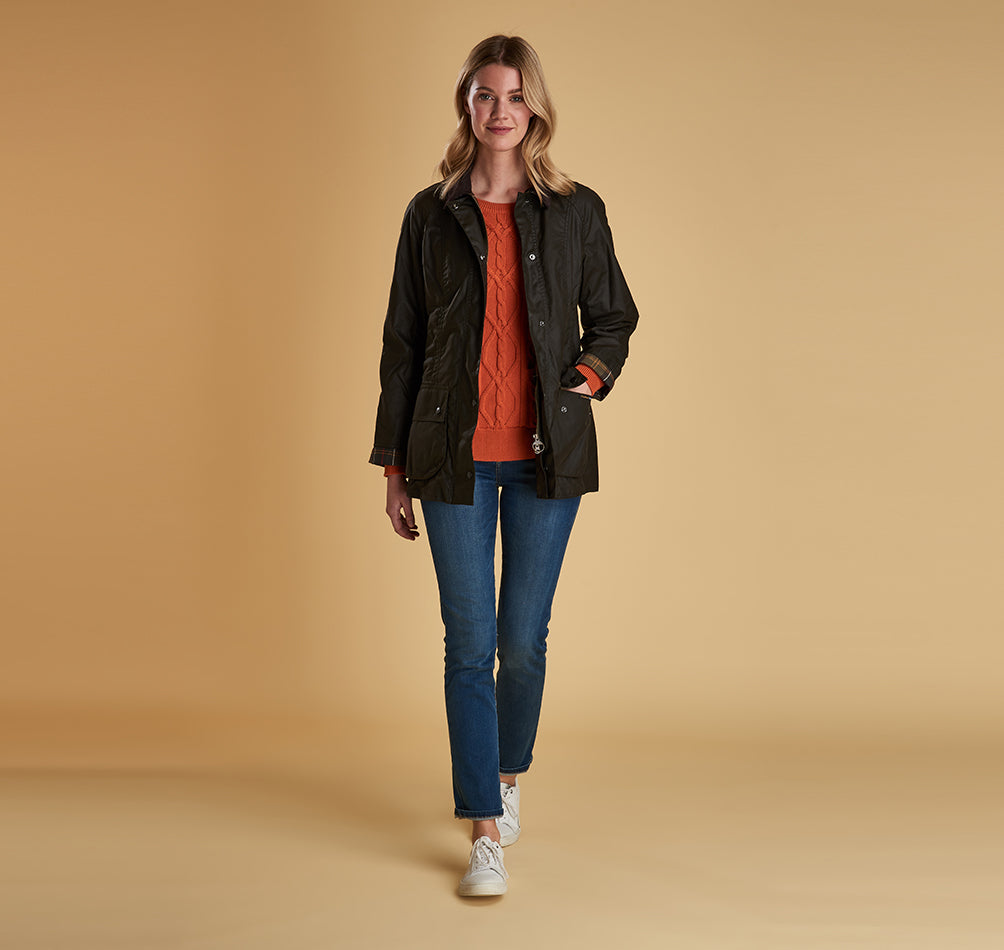 Model wearing Barbour Beadnell wax jacket in olive.