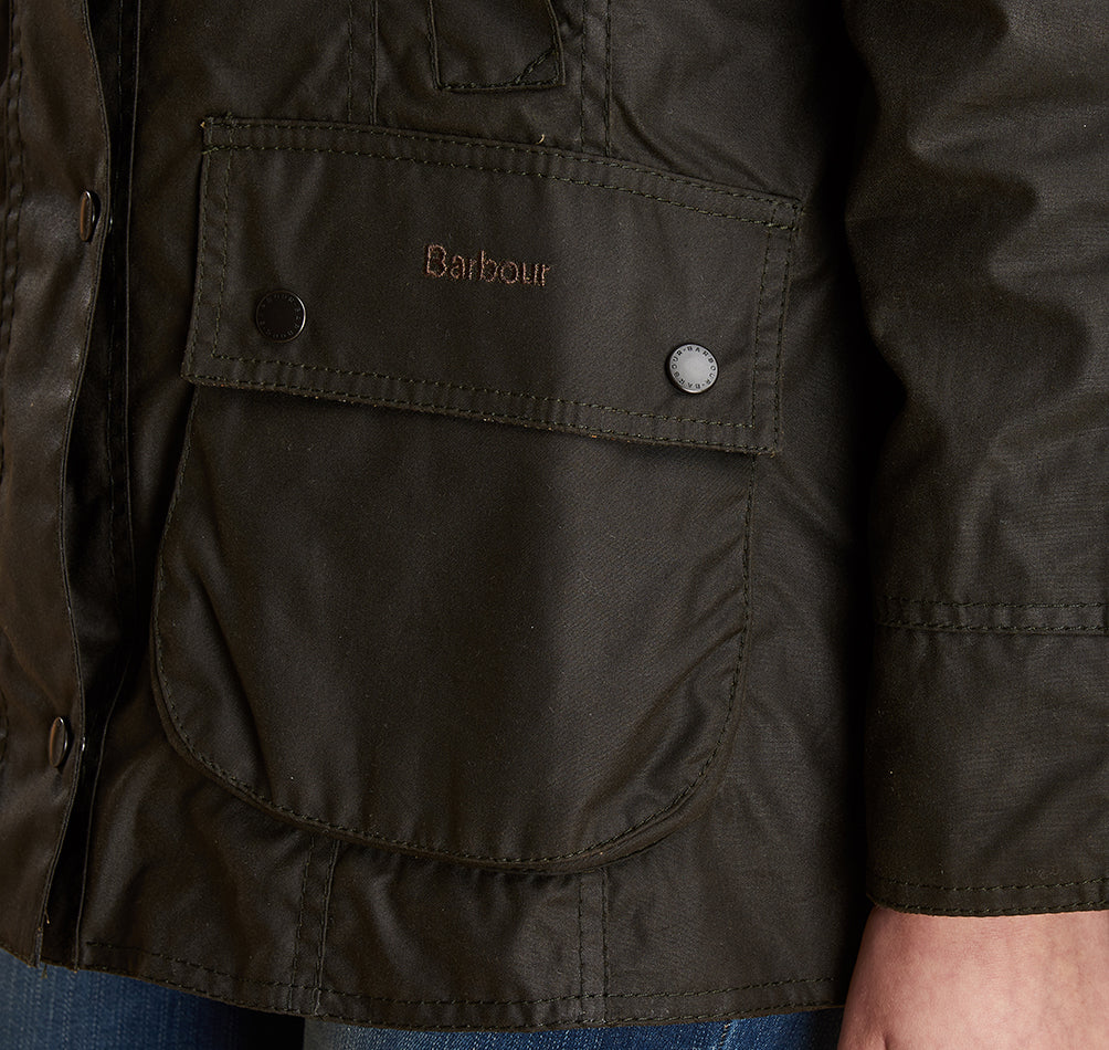 Model wearing Barbour Beadnell wax jacket in olive.