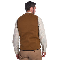 Load image into Gallery viewer, Back of Model wearing Barbour Warm Pile Waistcoat Zip-In Liner in brown.
