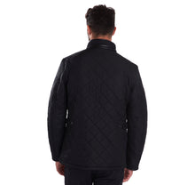 Load image into Gallery viewer, Back of model wearing Barbour Powell Quilt jacket in black.
