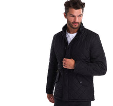 Load image into Gallery viewer, Model wearing Barbour Powell Quilt jacket in black.
