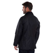 Load image into Gallery viewer, Back view of a model wearing a Barbour Ashby waxed jacket in black.
