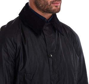 Model wearing a Barbour Ashby waxed jacket in black.