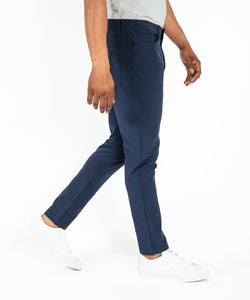 Model wearing Public Rec Workday Pant straight leg in navy.