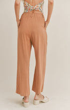 Load image into Gallery viewer, Model wearing Sadie &amp; Sage - Out West Linen Pants in Tan.
