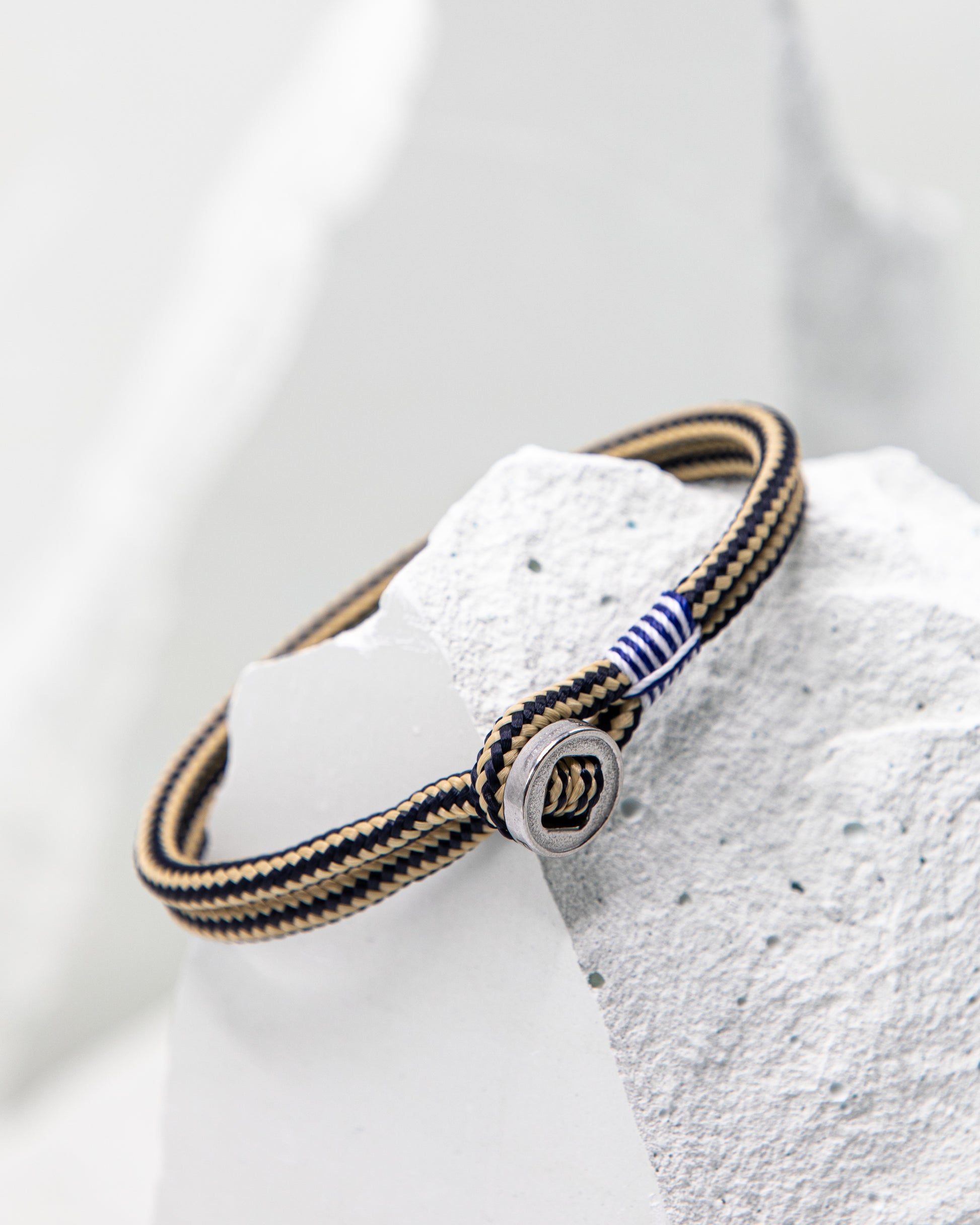 Pig & Hen Don Dino bracelet in navy / sand with silver ring.