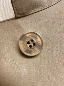 Mackintosh women's tan raincoat's button.