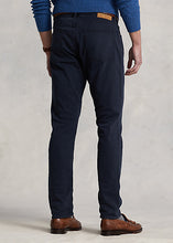 Load image into Gallery viewer, Model wearing POLO Ralph Lauren - Sullivan Slim Knitlike Chino Pant in Avaitor Navy - back.
