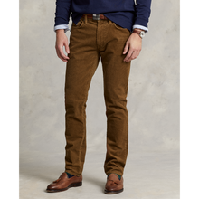 Load image into Gallery viewer, Model wearing Polo Ralph Lauren - Varick Slim Straight Stretch Corduroy 5-Pocket Pant in Sepia.
